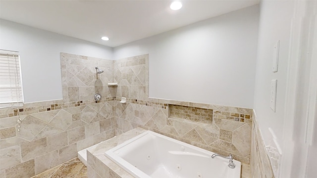 bathroom with a relaxing tiled tub