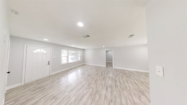 interior space featuring light hardwood / wood-style floors and vaulted ceiling