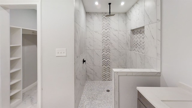 bathroom featuring vanity and tiled shower