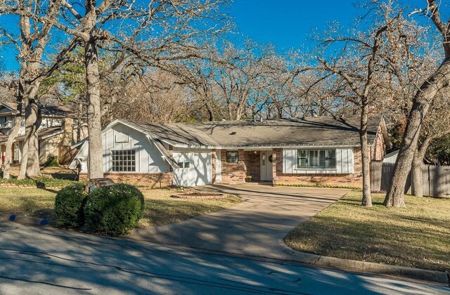 ranch-style home featuring a garage and a front yard