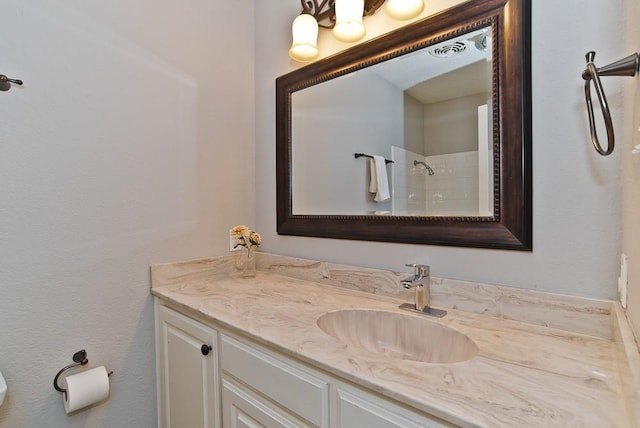 bathroom featuring vanity and walk in shower