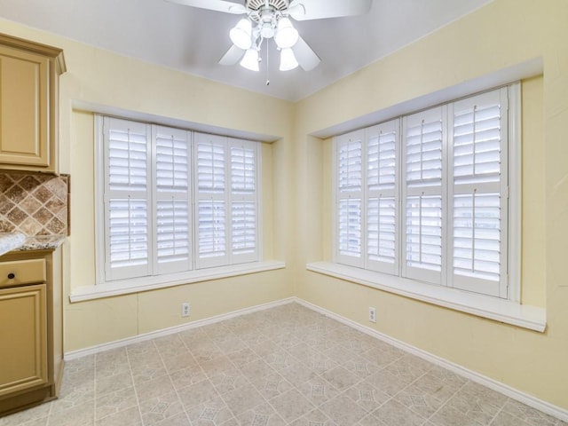 unfurnished dining area featuring ceiling fan