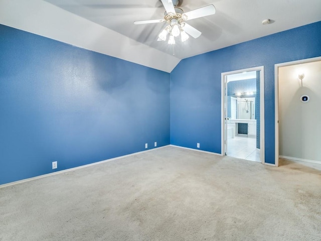 carpeted empty room featuring ceiling fan and lofted ceiling