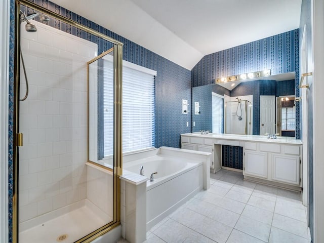 bathroom featuring tile patterned floors, vanity, independent shower and bath, and vaulted ceiling