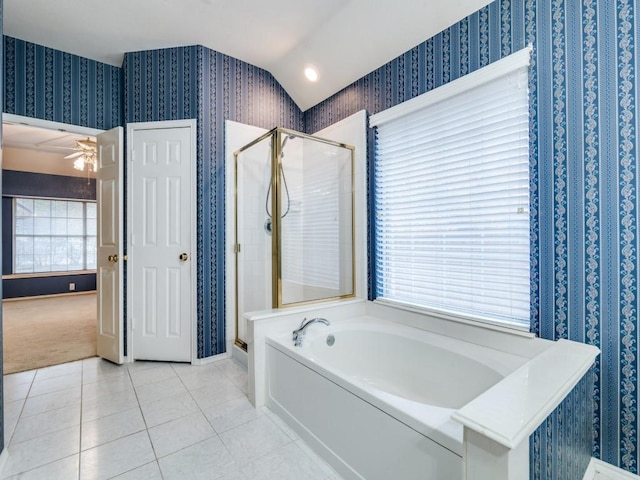 bathroom with ceiling fan, tile patterned flooring, plus walk in shower, and a healthy amount of sunlight