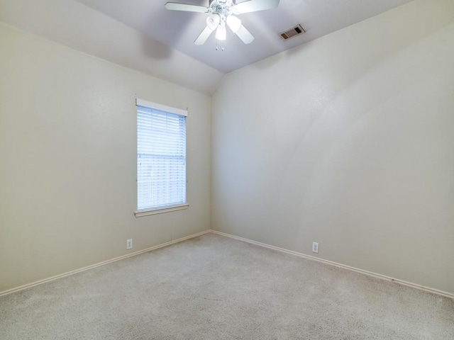 carpeted empty room with vaulted ceiling and ceiling fan