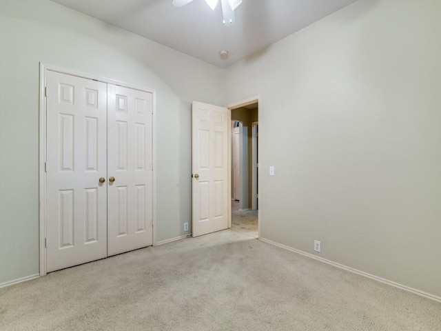 unfurnished bedroom with a closet, ceiling fan, and light colored carpet