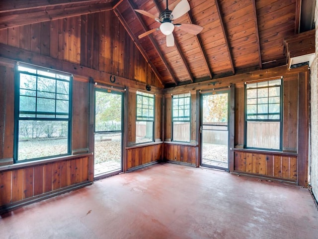 unfurnished sunroom featuring vaulted ceiling with beams, plenty of natural light, ceiling fan, and wooden ceiling