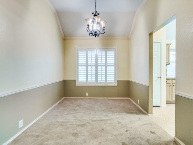 carpeted spare room featuring an inviting chandelier