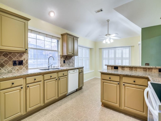 kitchen with backsplash, ceiling fan, sink, and white appliances