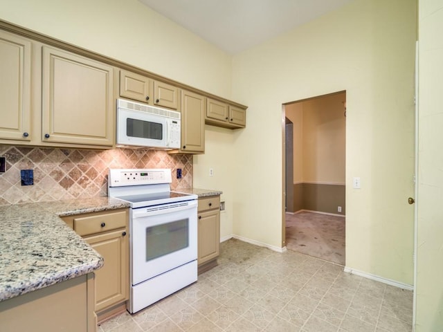 kitchen featuring light brown cabinets, white appliances, light stone counters, and backsplash