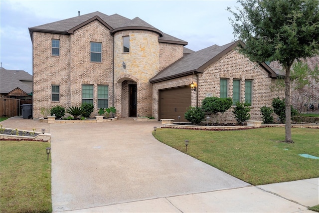 french country style house featuring a garage and a front lawn