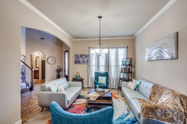 living room featuring crown molding, a chandelier, and hardwood / wood-style flooring