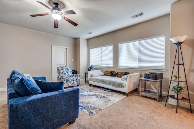 living room featuring light colored carpet and ceiling fan