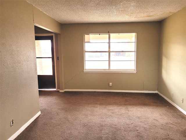 carpeted spare room featuring a textured ceiling