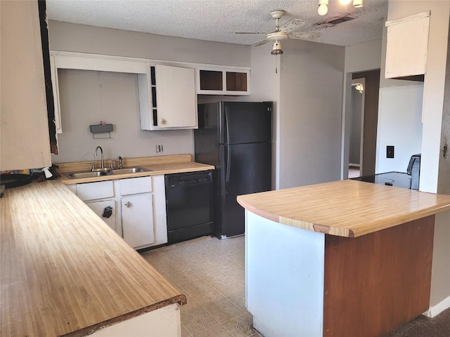 kitchen featuring kitchen peninsula, sink, white cabinets, and black appliances