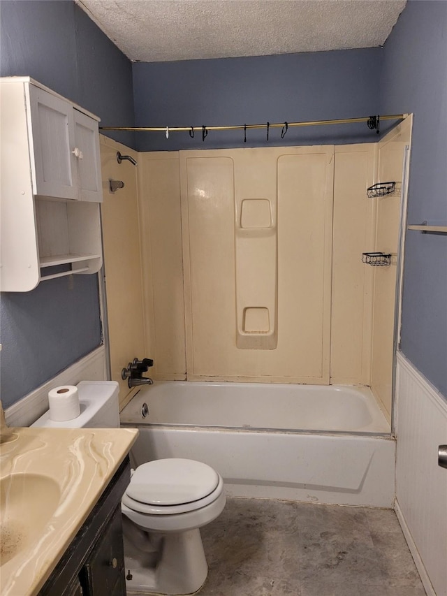 full bathroom featuring shower / washtub combination, vanity, a textured ceiling, and toilet