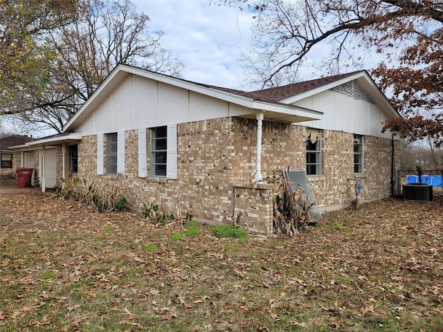 view of side of home featuring cooling unit and a garage