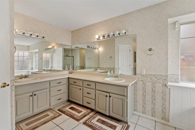 bathroom with tile patterned floors, vanity, and tile walls