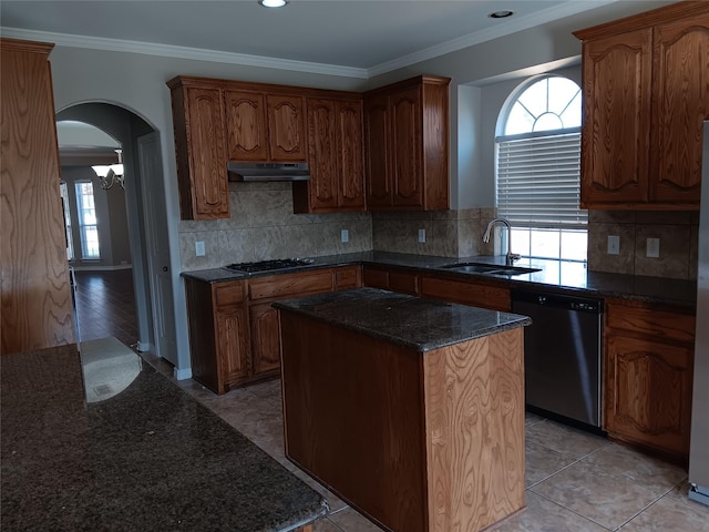 kitchen featuring sink, gas cooktop, dishwasher, ornamental molding, and a kitchen island