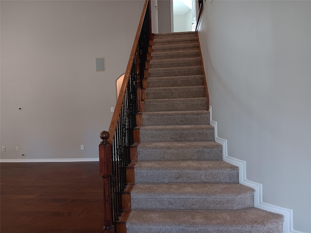 staircase with hardwood / wood-style floors