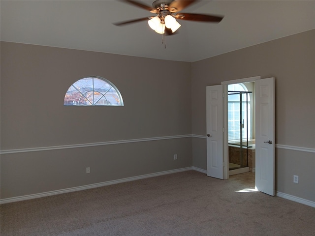 unfurnished room with light colored carpet and ceiling fan