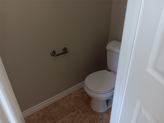 bathroom with tile patterned flooring and toilet