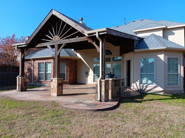 back of house featuring a yard and a patio area