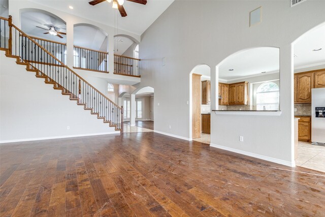 unfurnished dining area featuring a decorative wall, a healthy amount of sunlight, wood finished floors, and visible vents