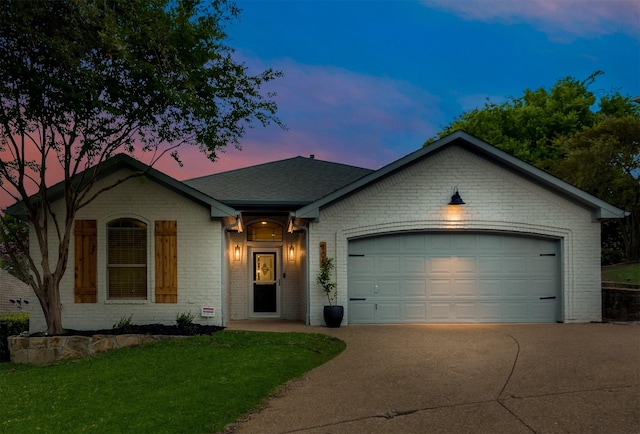 single story home featuring a garage and a lawn