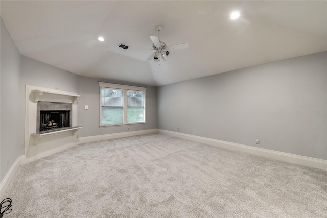 unfurnished living room with light carpet, vaulted ceiling, and ceiling fan