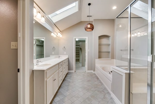 bathroom with shower with separate bathtub, vanity, and lofted ceiling with skylight