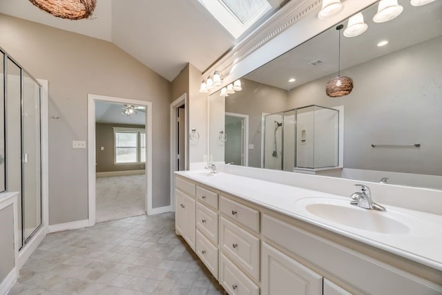 bathroom with lofted ceiling with skylight, vanity, and an enclosed shower