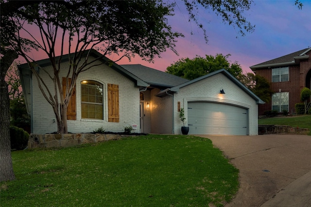 view of front facade with a lawn and a garage