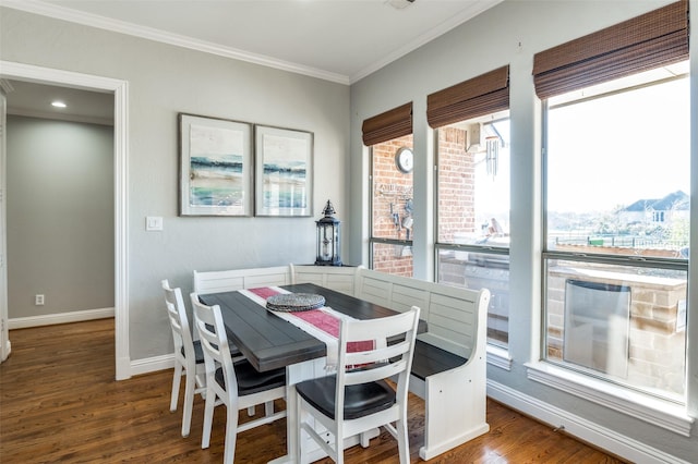 dining space with hardwood / wood-style floors and ornamental molding