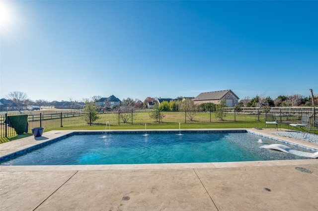 view of swimming pool with pool water feature, a patio, and a lawn