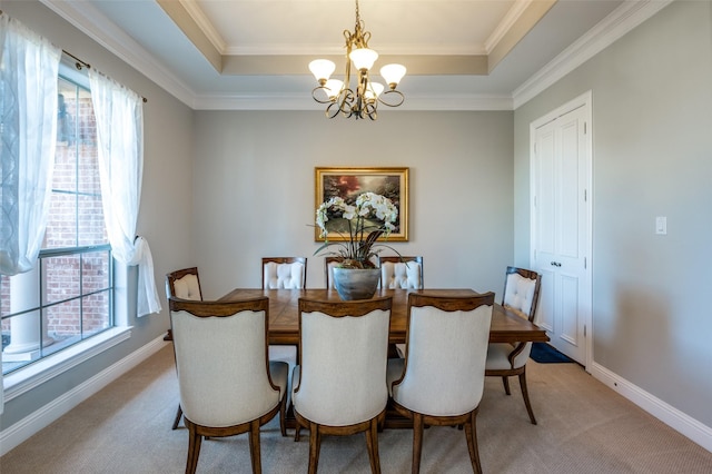 dining space with a chandelier, a tray ceiling, and a healthy amount of sunlight