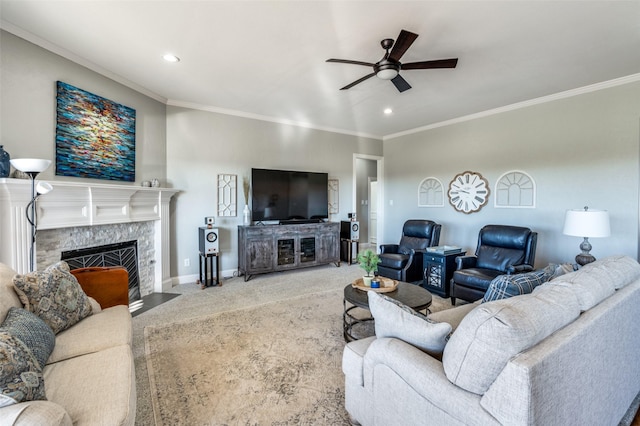 living room featuring a fireplace, carpet floors, ceiling fan, and crown molding