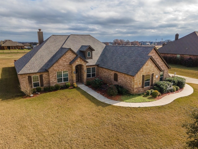 119 Remington Park Dr, Springtown, TX 76082 - french provincial home with stone siding, a chimney, roof with shingles, and a front yard