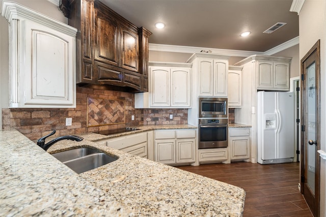 119 Remington Park Dr, Springtown, TX 76082 - kitchen with decorative backsplash, dark wood-style flooring, crown molding, appliances with stainless steel finishes, and a sink