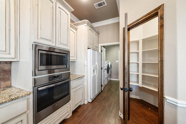 119 Remington Park Dr, Springtown, TX 76082 - kitchen with ornamental molding, stainless steel appliances, washing machine and clothes dryer, visible vents, and wood tiled floor
