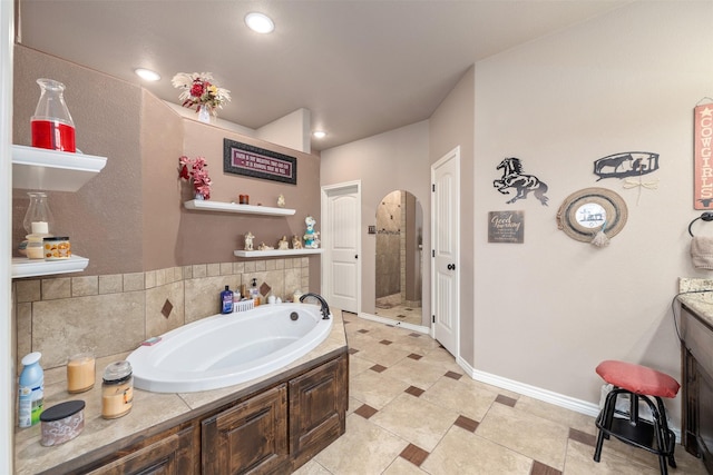 bathroom featuring separate shower and tub