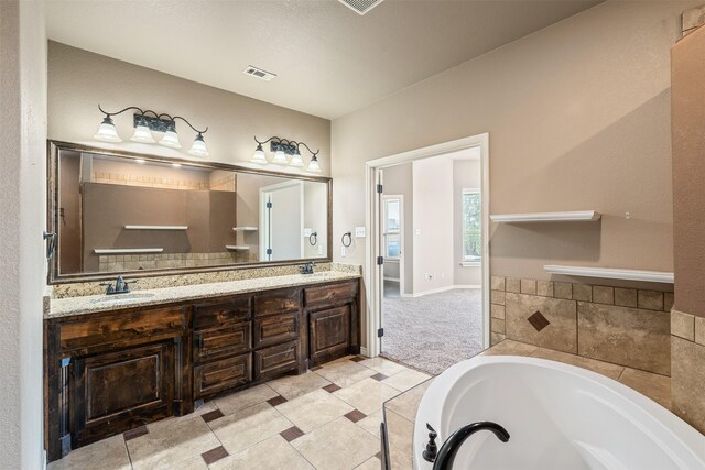 119 Remington Park Dr, Springtown, TX 76082 - full bathroom with double vanity, a bath, visible vents, and a sink
