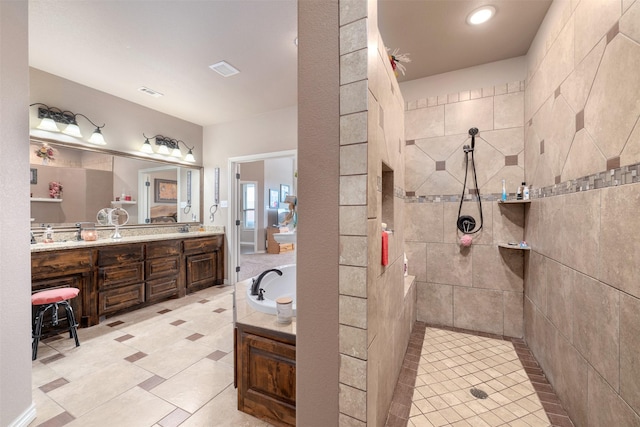 bathroom with vanity and independent shower and bath