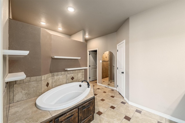 119 Remington Park Dr, Springtown, TX 76082 - bathroom with baseboards, a tile shower, a garden tub, and recessed lighting