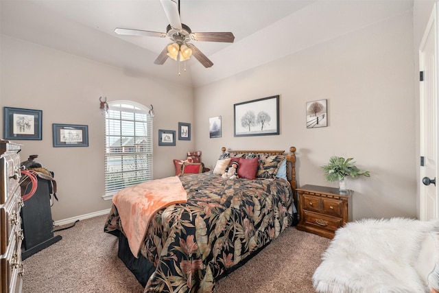 carpeted bedroom with ceiling fan and vaulted ceiling