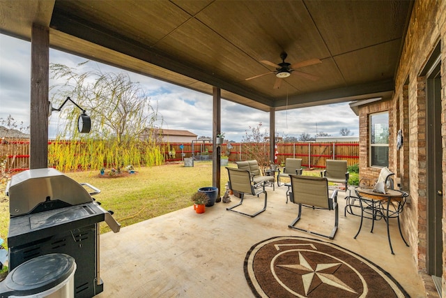 view of patio with ceiling fan and a grill