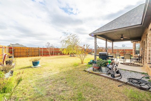 view of yard featuring a patio area and ceiling fan