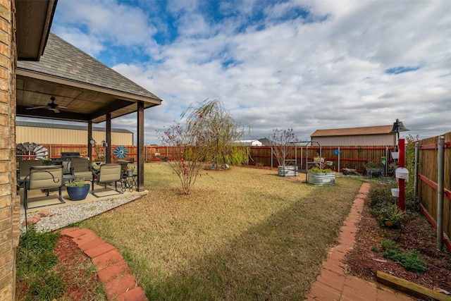 view of yard featuring ceiling fan and a patio