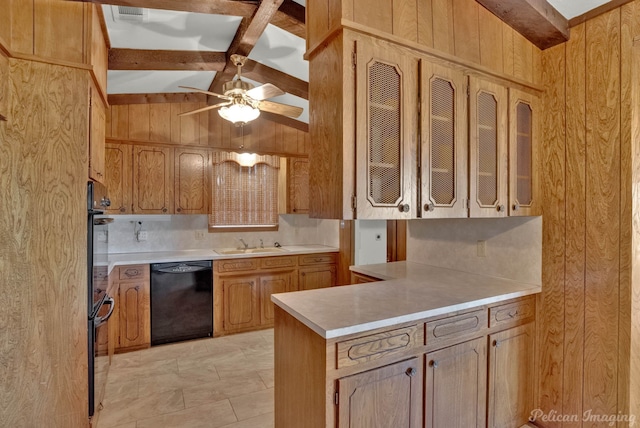 kitchen featuring wood walls, vaulted ceiling with beams, black dishwasher, sink, and ceiling fan